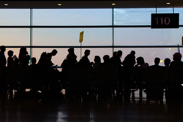 Busy airport terminal with people waiting