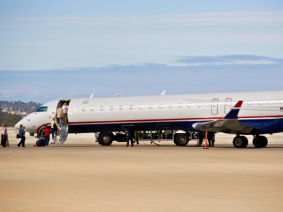 Passengers boarding commercial airliner charter regional jet