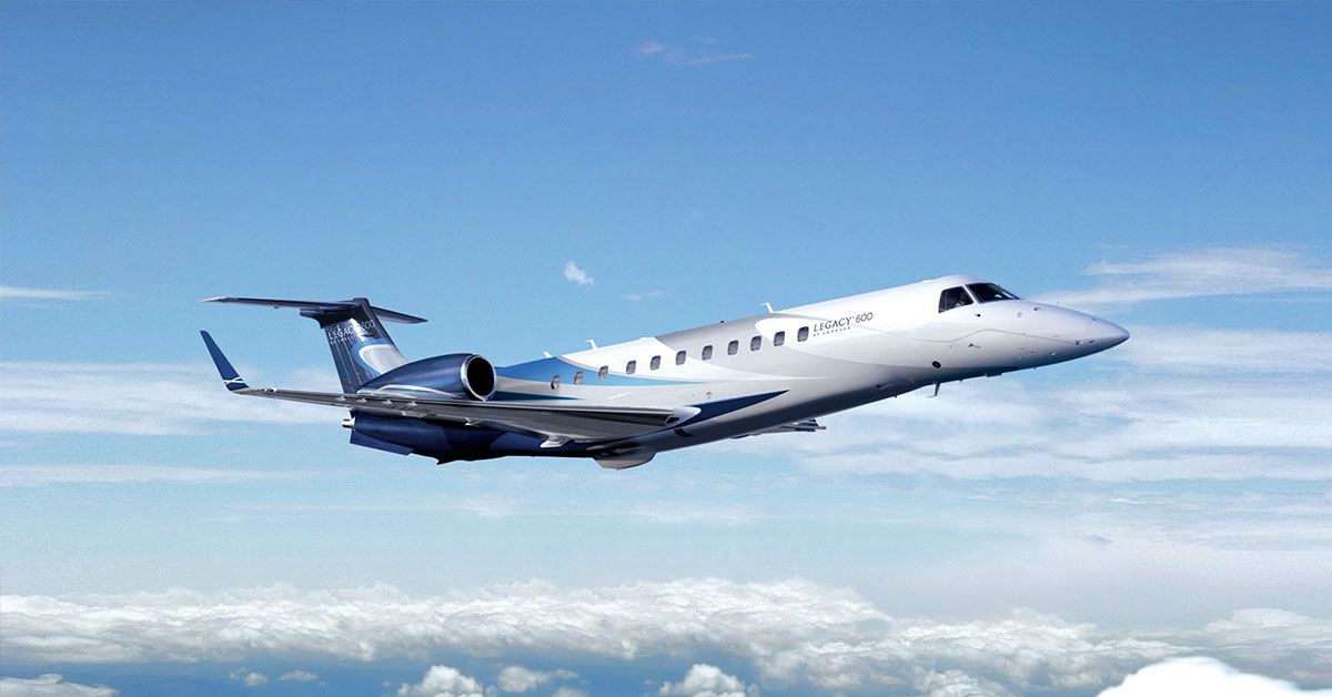 Embraer Legacy 600 private jet charter flight over clouds