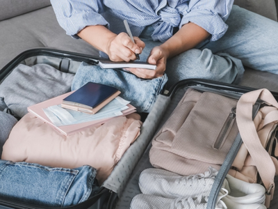 Woman packing light for private flight, get into travel mode