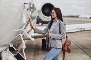 Young woman boarding private jet