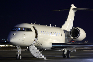 Corporate jet on airport runway at night